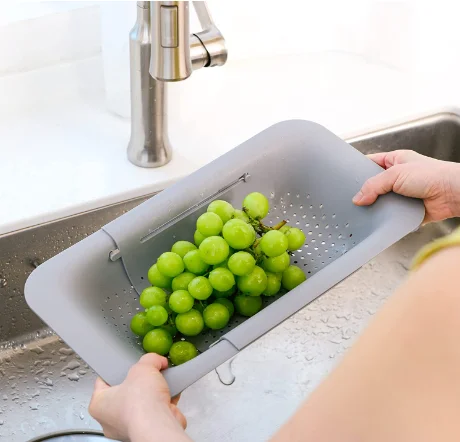 Collection of 11 innovative kitchen gadgets displayed on a bright countertop, showcasing must-have appliances under $80.