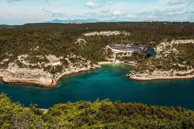 Dramatic coastal cliffs along the shore of Corsica, one of the most beautiful islands in the Mediterranean, with turquoise sea below.