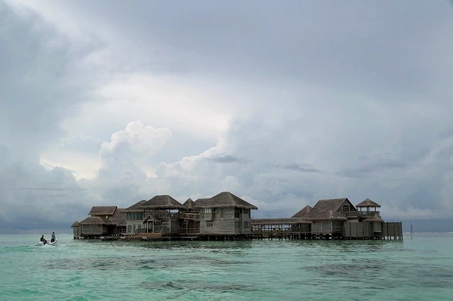 Overwater villas in the Maldives, one of the most beautiful islands, set against clear turquoise waters and vibrant coral reefs.