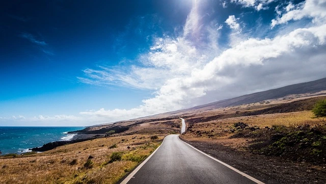 Scenic view of Maui, known as one of the most beautiful islands, featuring its black sand beach at Wai'anapanapa State Park with crystal-clear waters.