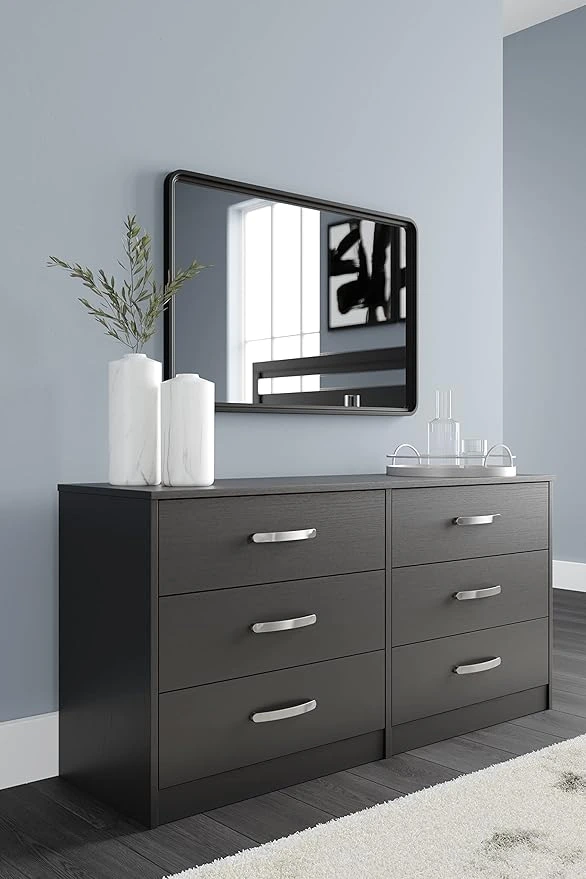 Signature Design by Ashley Finch Modern 6-Drawer Chest, sleek black dresser with ball-bearing construction for smooth drawer operation and safety stop feature, ideal for bedroom storage and organization.